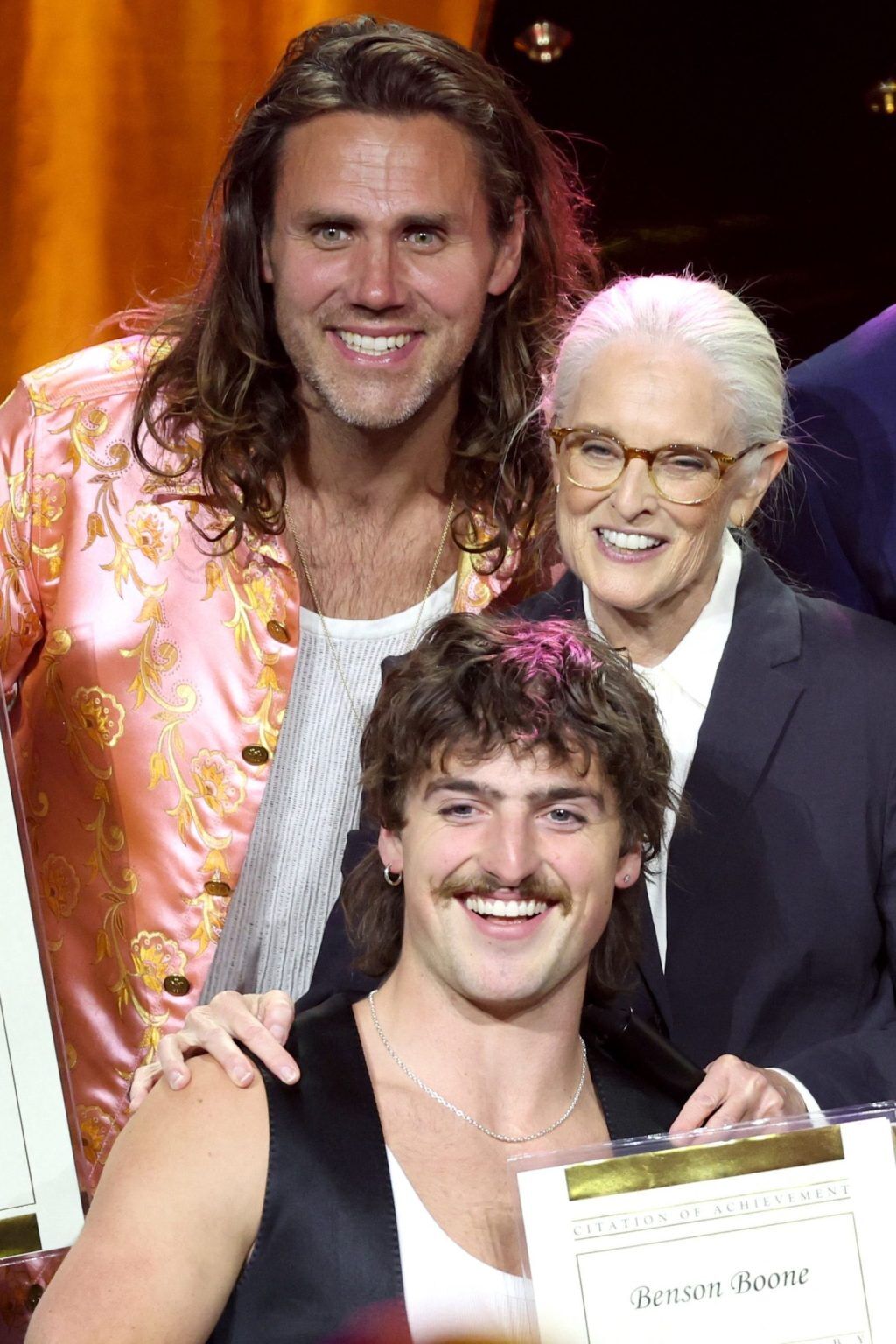 BEVERLY HILLS, CALIFORNIA - MAY 13: Barbara Cane, Vice President, Worldwide Creative, BMI, and Advisor to Executive Vice President, Chief Revenue & Creative Officer, BMI (C) presents a BMI Pop Award to Jason Evigan (top) and Benson Boone (bottom) onstage during the 2025 BMI Pop Awards at Beverly Wilshire, A Four Seasons Hotel, on May 13, 2025 in Beverly Hills, California. (Photo by JC Olivera/Getty Images for BMI)